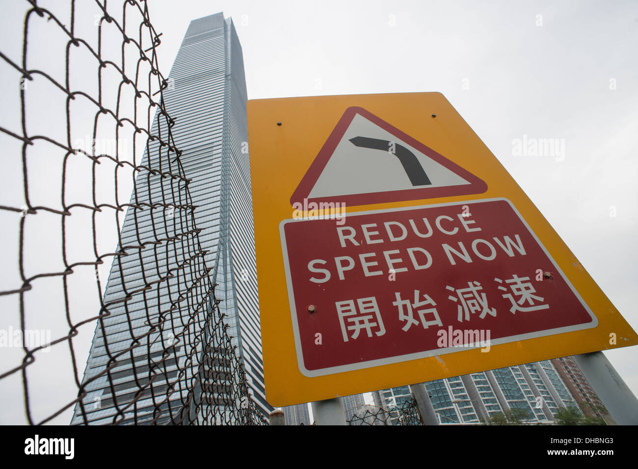 This image shows a reduce speed sign, near the the International Commerce Center in West Kowloon, Hong Kong on 06 November, 2013 Stock Photo