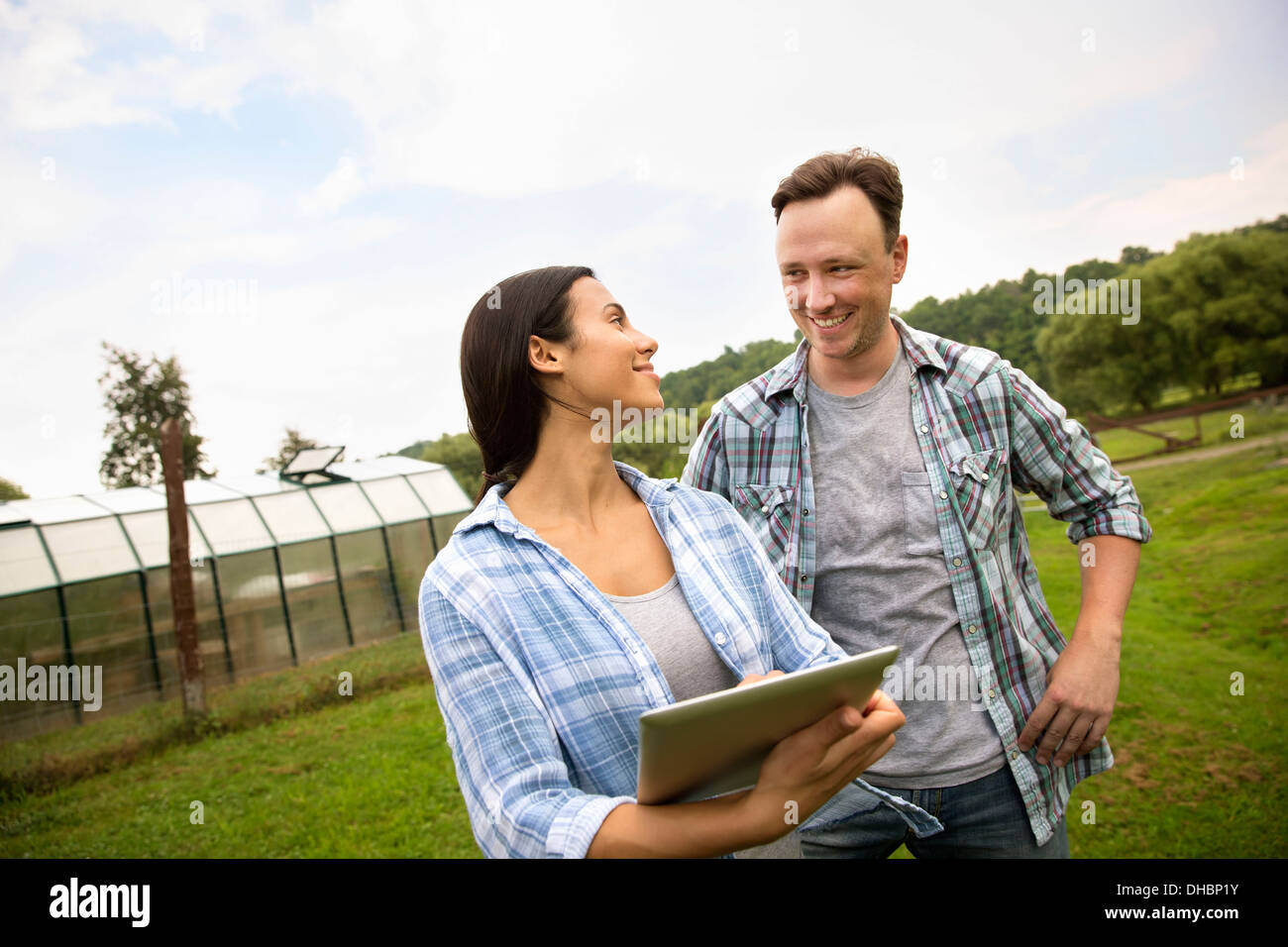 An organic farm in the Catskills. Two people using a digital tablet outdoors. Stock Photo