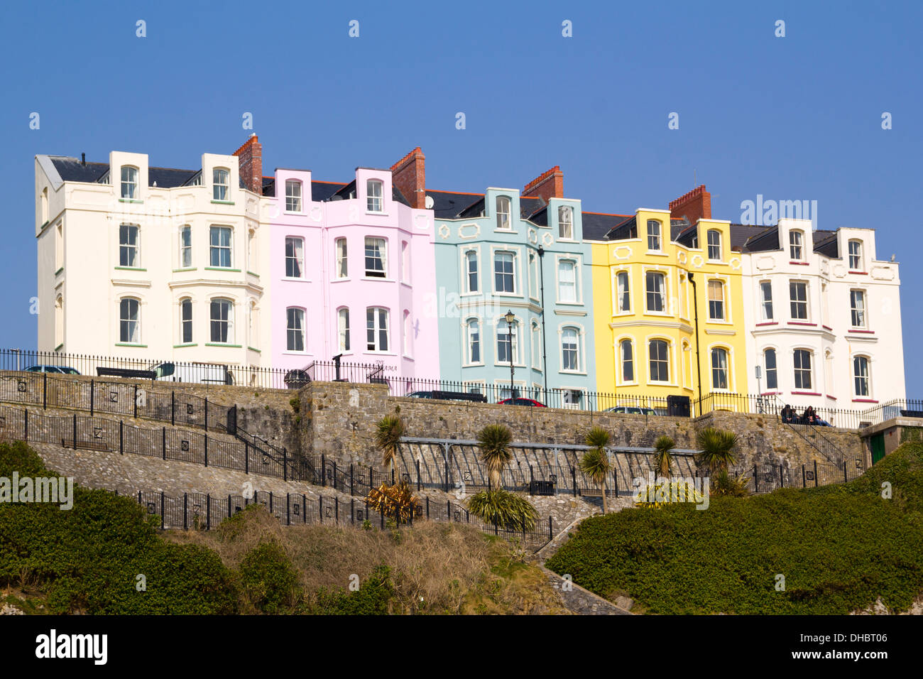 Pastel coloured hotel frontages in a terraced row on the Esplanade at Tenby, Pembrokeshire, Wales, UK Stock Photo