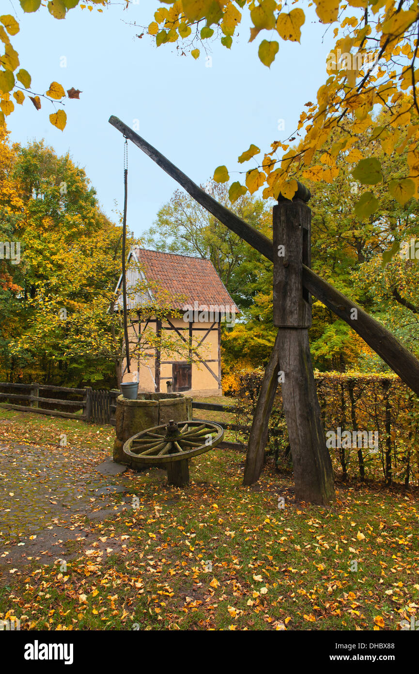Old well in front of a fortified tower and storehouse from the fifteenth century, Germany, Europe Stock Photo
