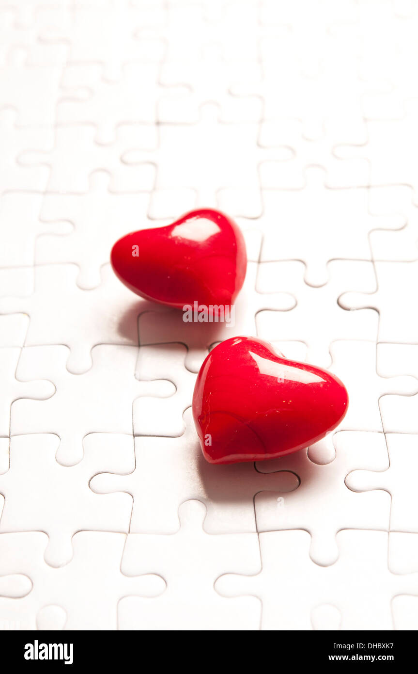 two valentine hearts on a jigsaw puzzle, love concept Stock Photo