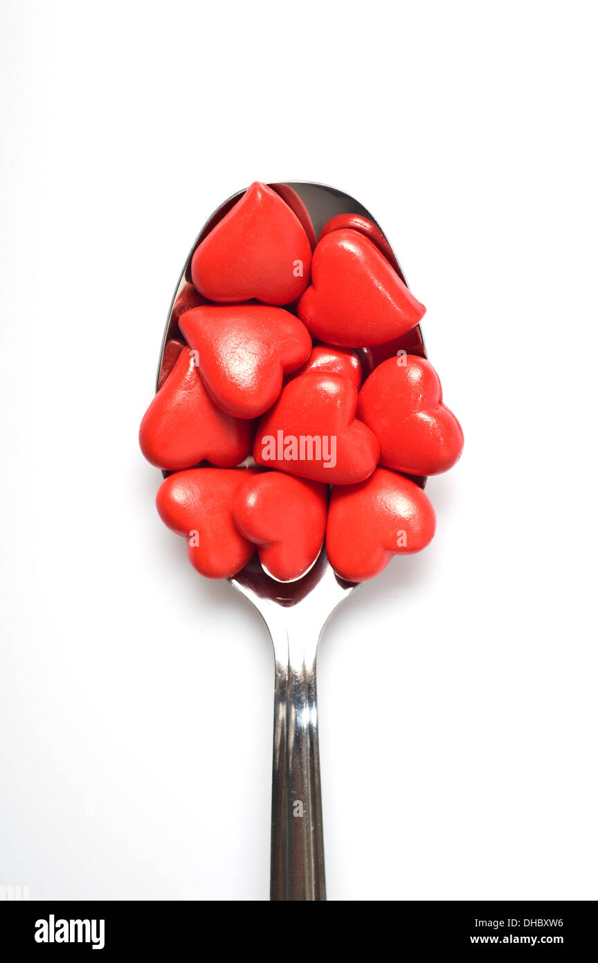 many valentine hearts in a spoon, spoon full of love Stock Photo