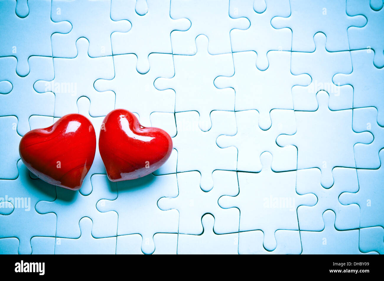 two valentine hearts on a jigsaw puzzle, love concept Stock Photo