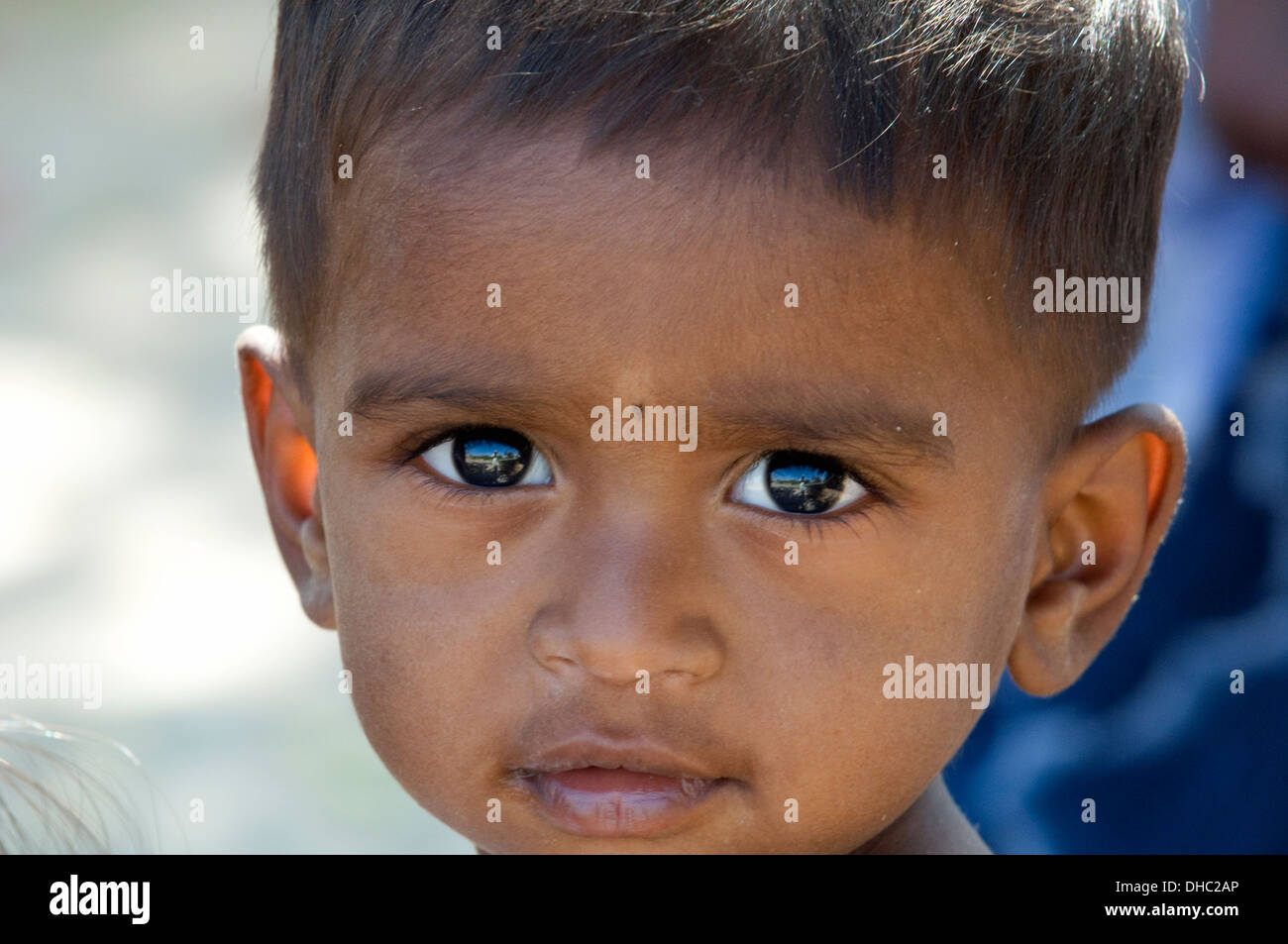 South Indian boy child with enchanting eyes studying the camera, photographer and life in Andhara Pradesh South India Stock Photo