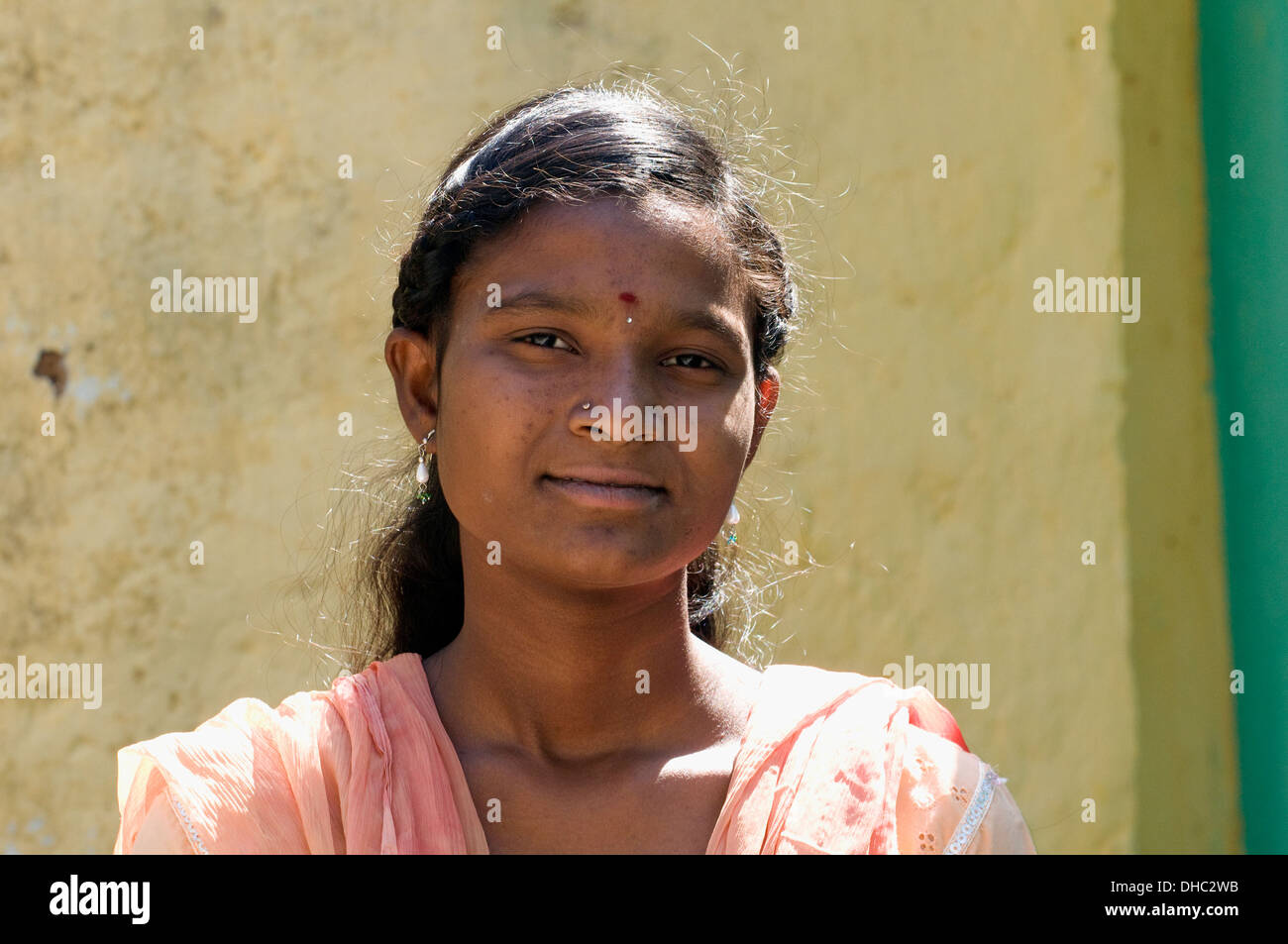 Portrait of a South Indian teenage girl stood in front of her family home in Puttaparthi Andhara Pradesh South India Stock Photo