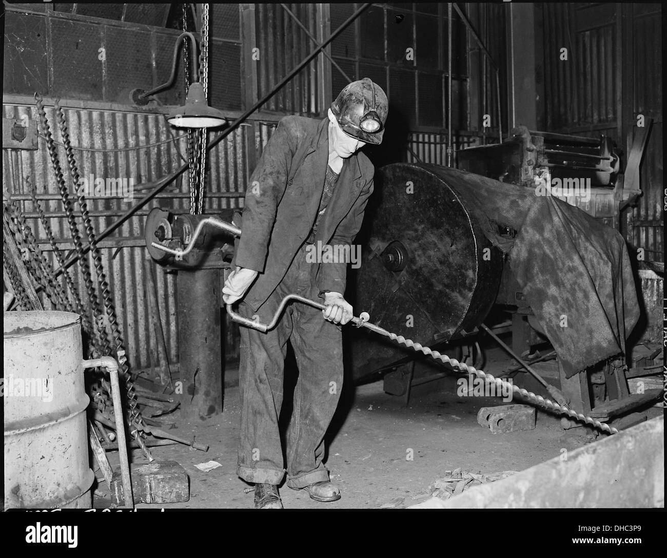 Harry Fain, coal loader assembles auger which he will use in drilling at the face. Inland Steel Company, Wheelwright... 541459 Stock Photo