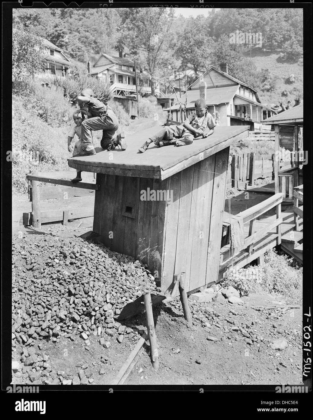Miner's children play on top of the Howard family privy. There is no place for children to play in this camp other... 540824 Stock Photo