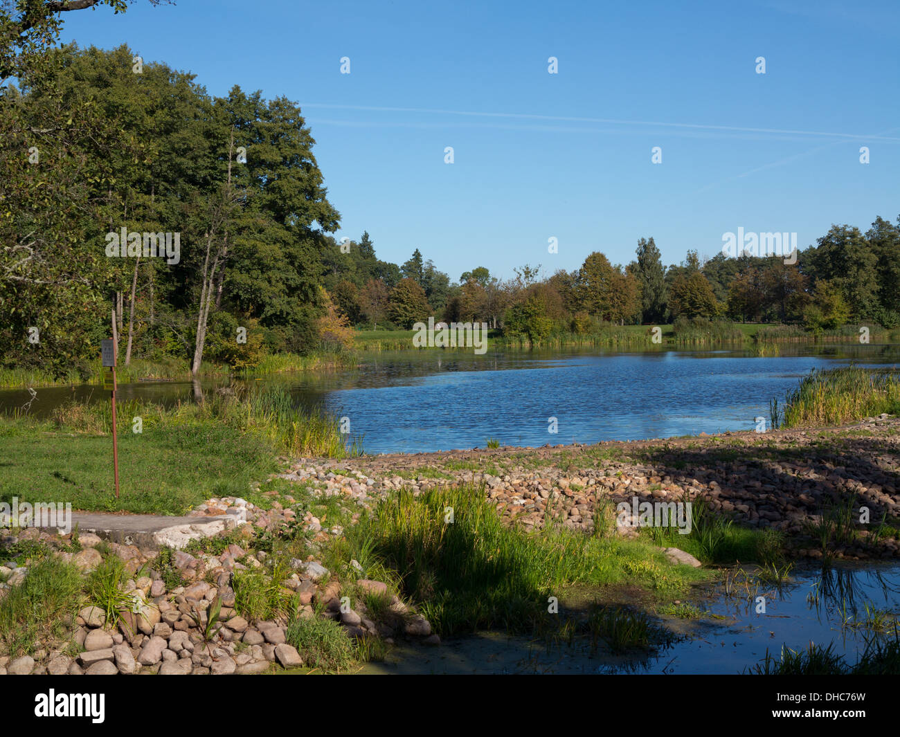Sunny afternoon Palace Park landscape in Bialowieza with pond Stock Photo