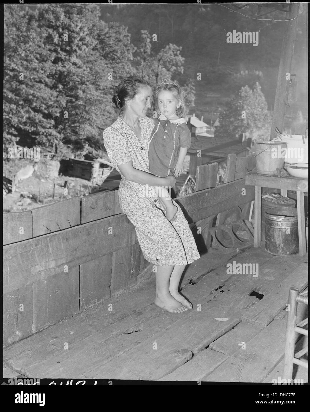 Mrs. Charlie Davis and her daughter on the front porch of their two room house. Coleman Fuel Company, Red Bird Mine... 541135 Stock Photo