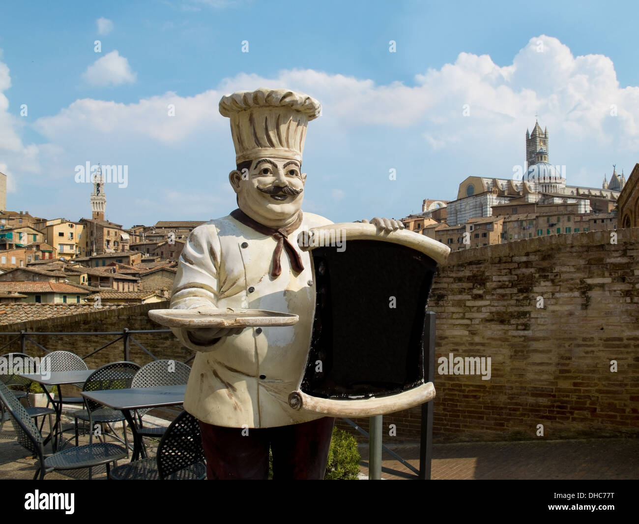 Figure of an Italian chef with the Siena´s panoramic view on his back. Siena, Italy Stock Photo
