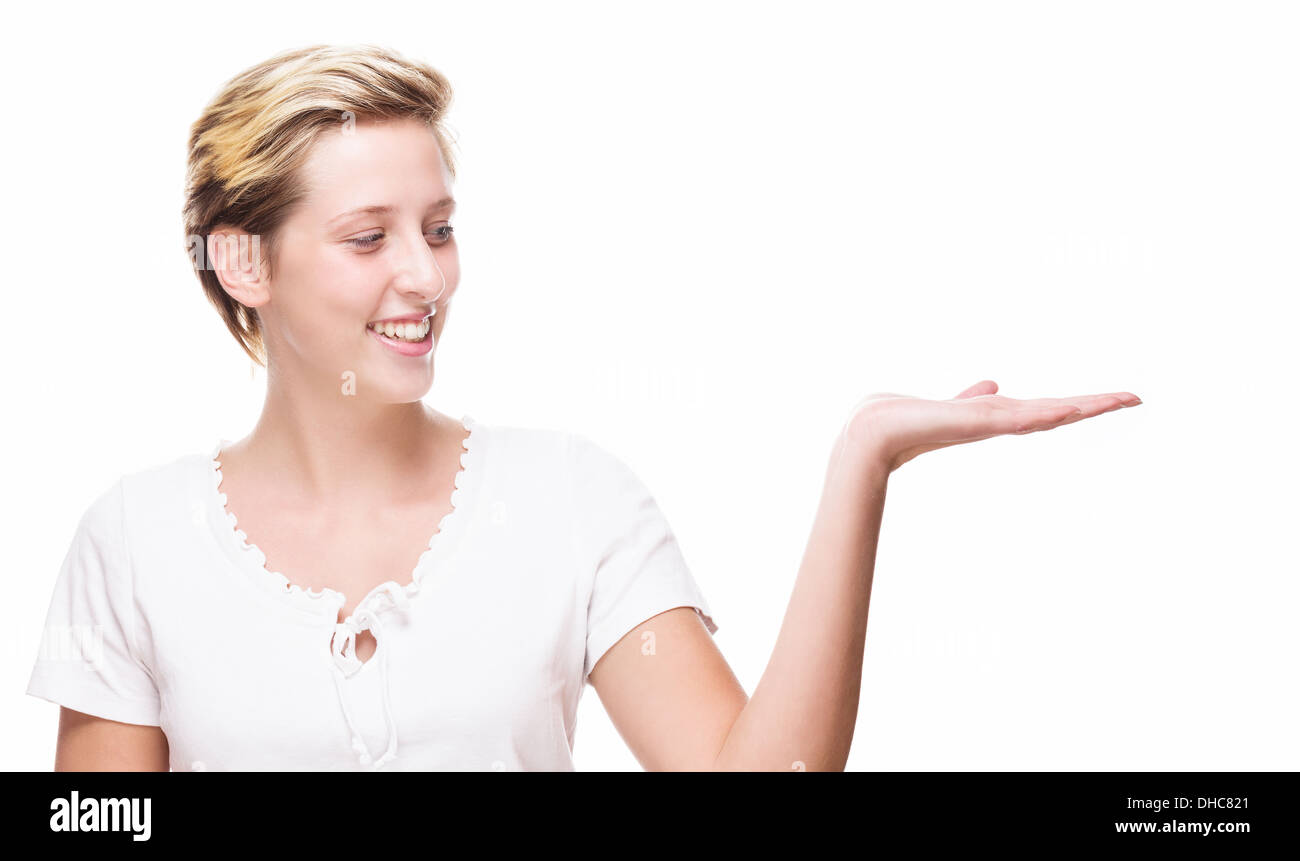 happy woman showing empty hand for product placement on white background Stock Photo