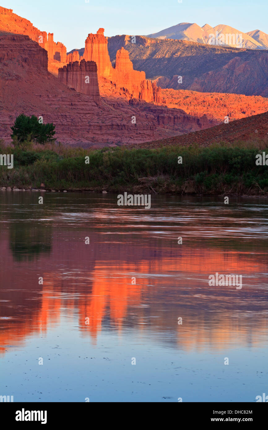 The Fisher Towers partially lit by the late afternoon sun reflected in the Colorado River near Moab,Utah Stock Photo