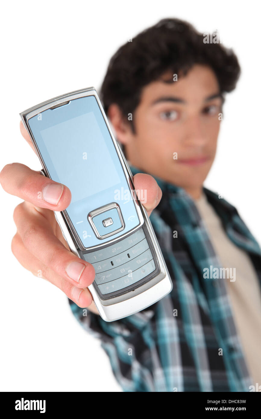 Teenage boy holding out mobile telephone Stock Photo Alamy