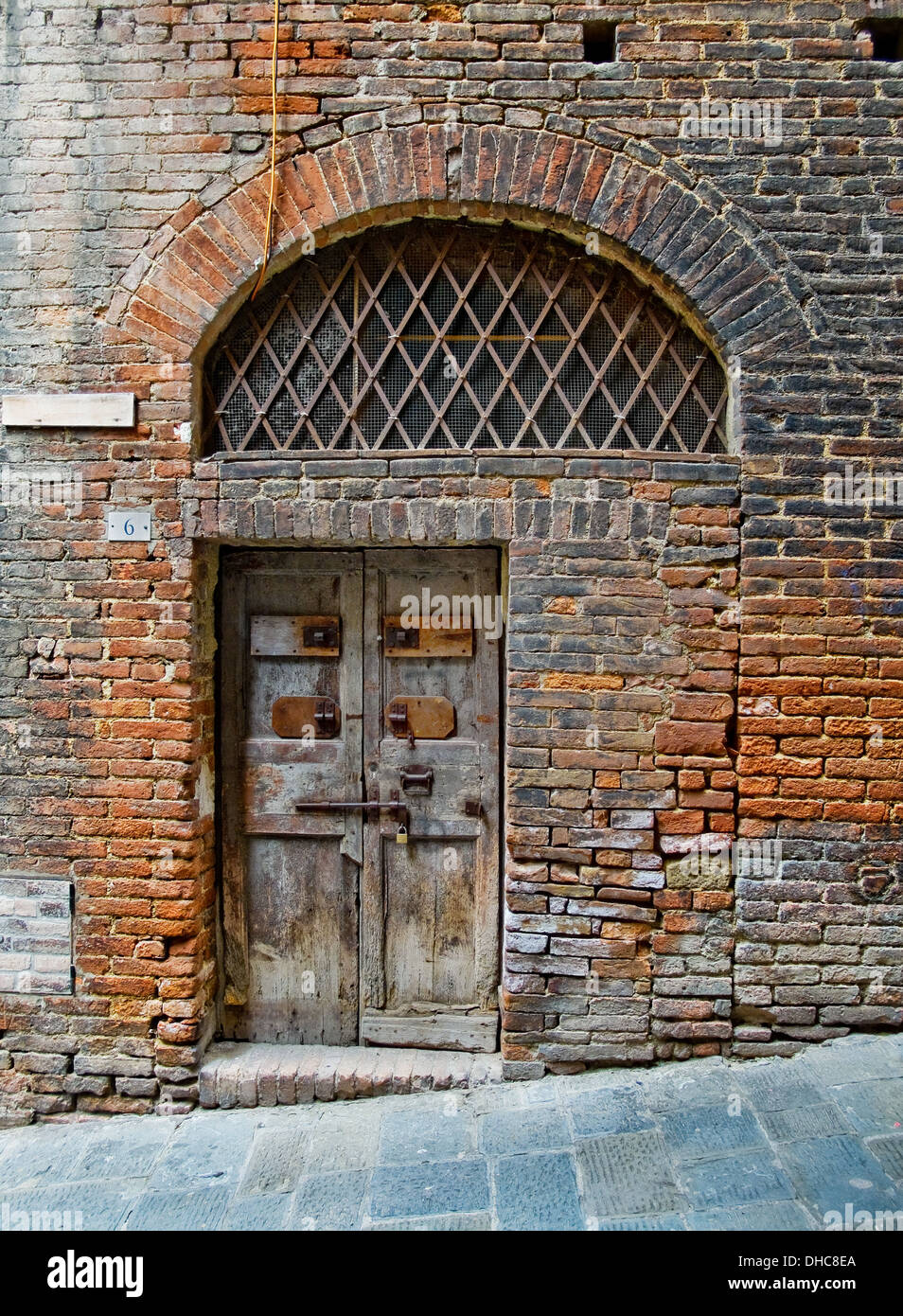 Antique wooden door in Siena street. Siena, Italy Stock Photo