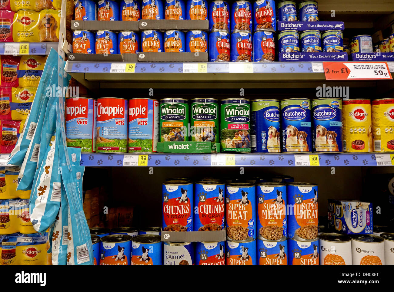 tins of dog food in a supermarket Stock Photo