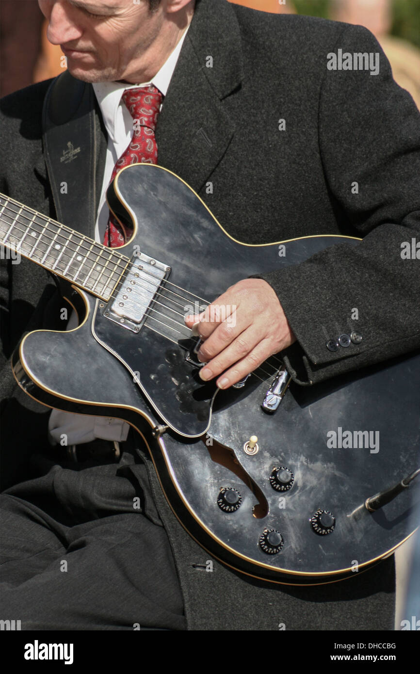 Electric guitar player busking in Bournemouth town center, England, UK