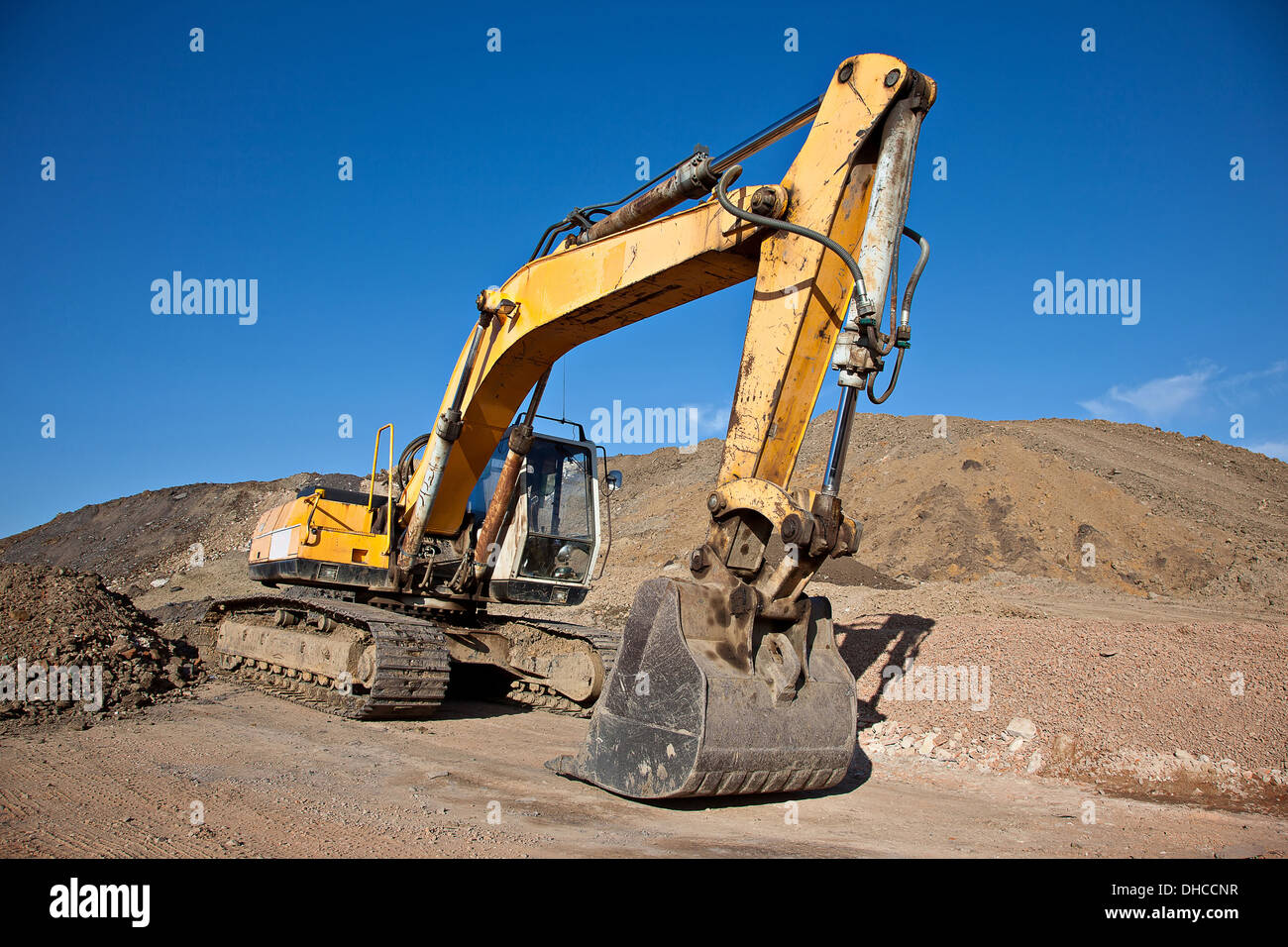 Excavator at a construction site with blue sky Stock Photo