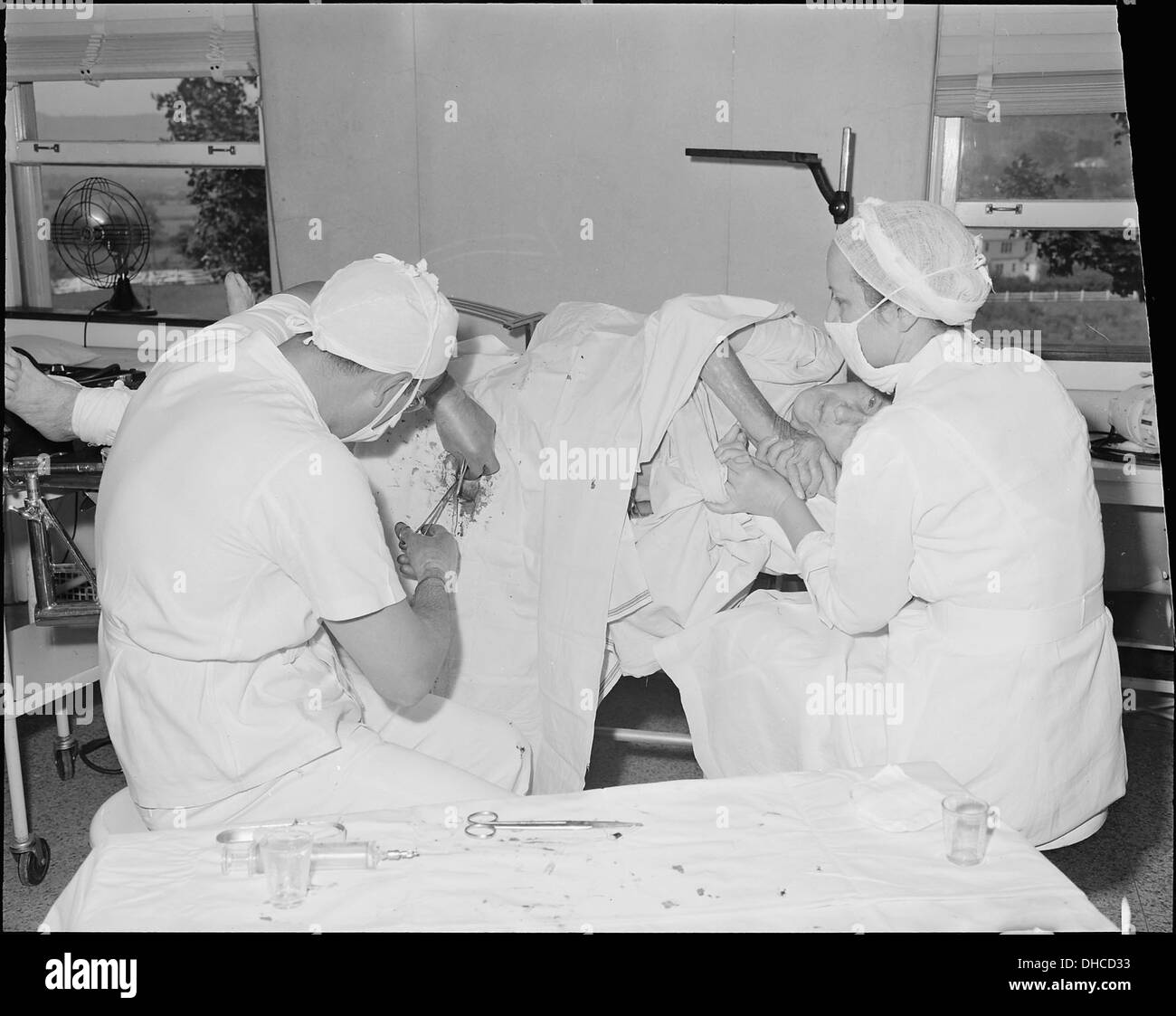 Surgeon putting pin in broken hip of an old lady. Clinch Valley Clinic