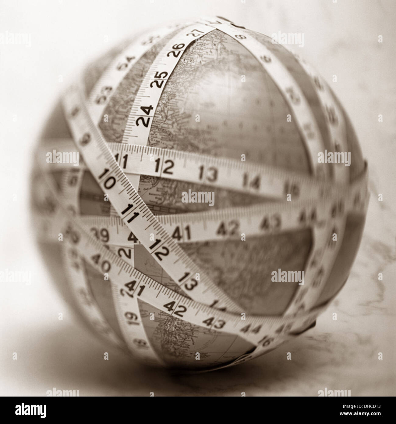 Measuring Tape Wrapped Around Globe Stock Photo