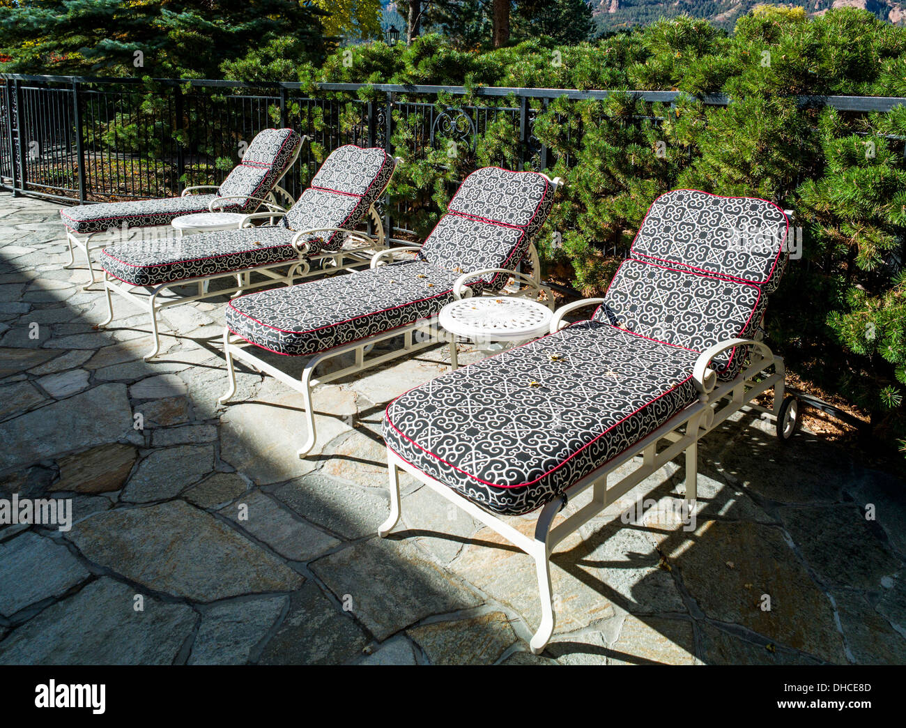 Chaise lounge chairs line a swimming pool, The Broadmoor, historic luxury hotel and resort, Colorado Springs, Colorado, USA Stock Photo