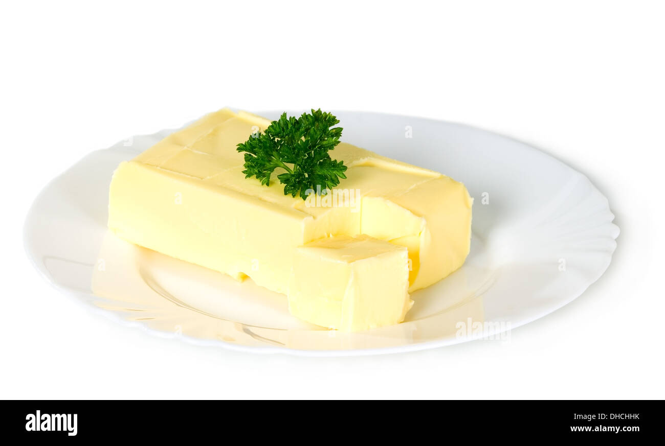 Yellow butter with parsley placed on plate, food concept Stock Photo