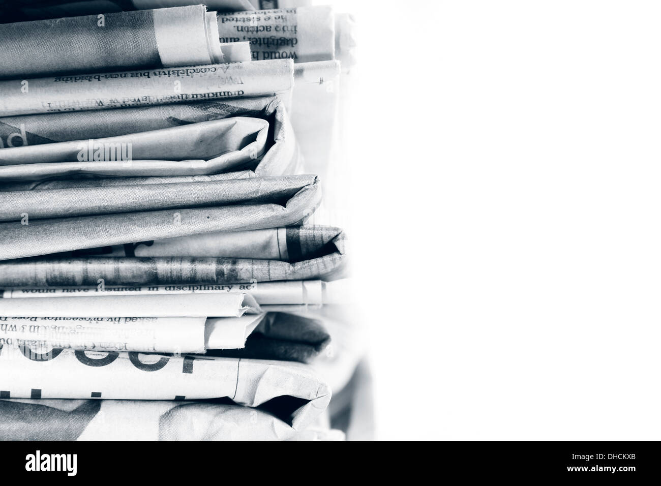 Closeup of newspapers on plain background Stock Photo