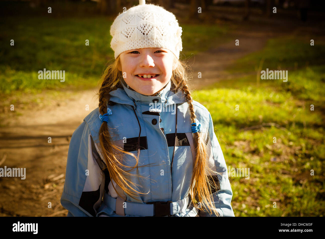 The healthy little girl smiling, walks in park in the autumn Stock Photo