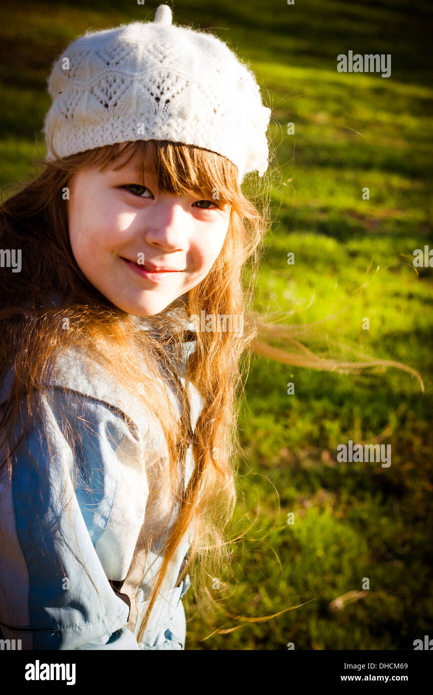 The healthy little girl smiling, walks in park in the autumn Stock Photo