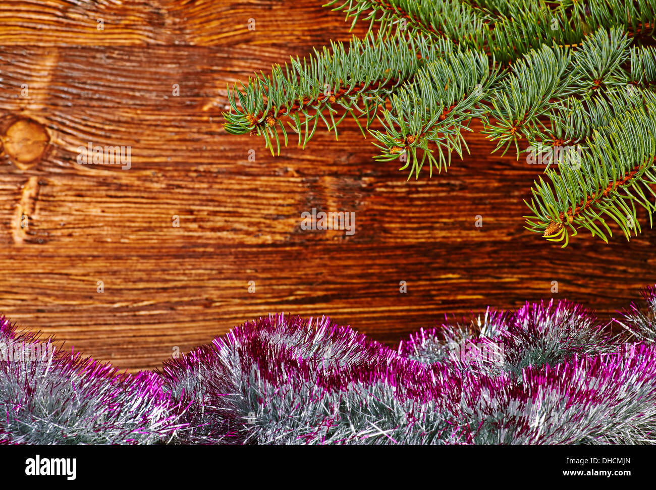 Christmas decoration. Fir-tree, tinsel and wooden background. Selective focus Stock Photo
