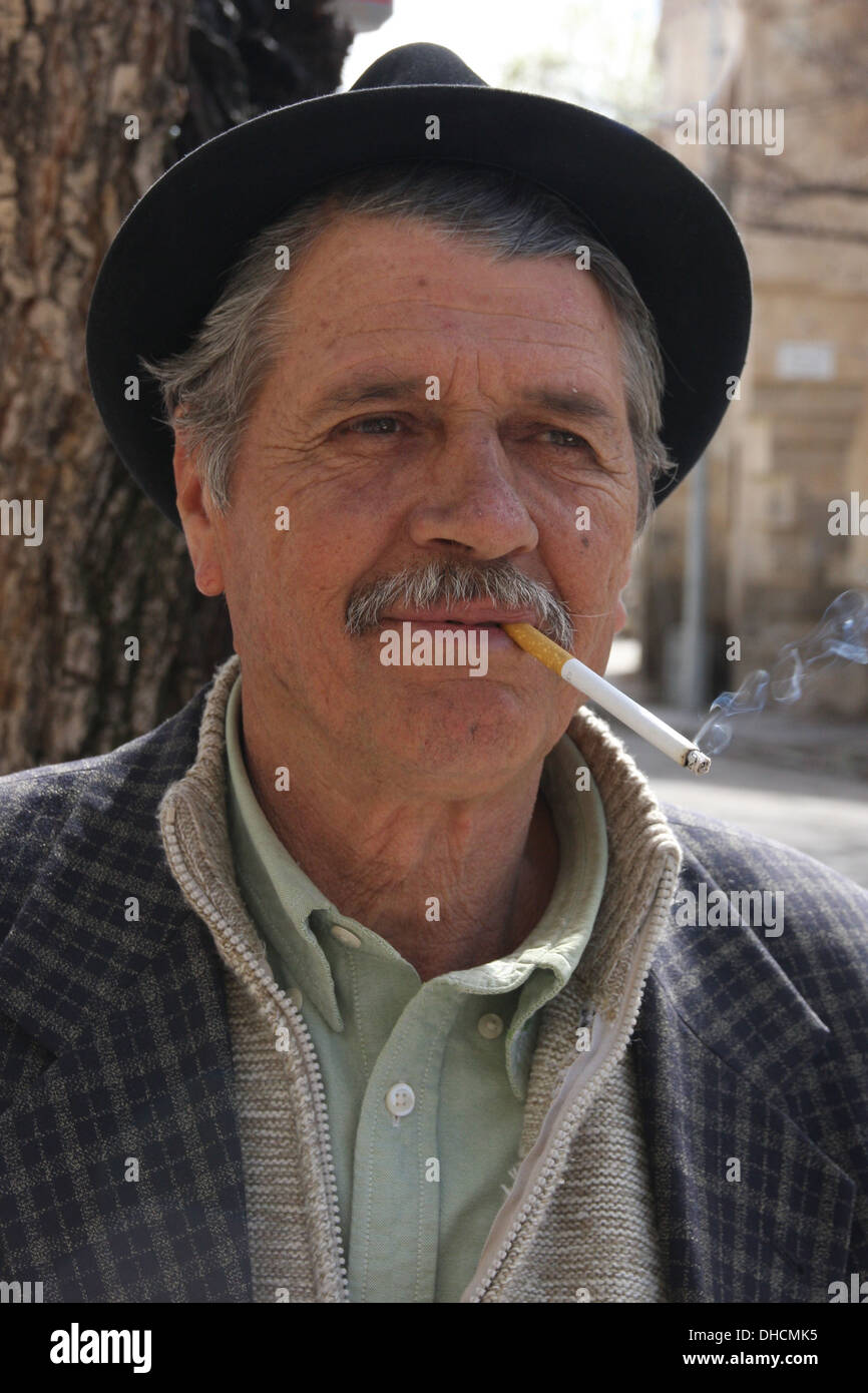 Traditional Muslim man in Istanbul, Turkey smoking a cigarette Stock Photo