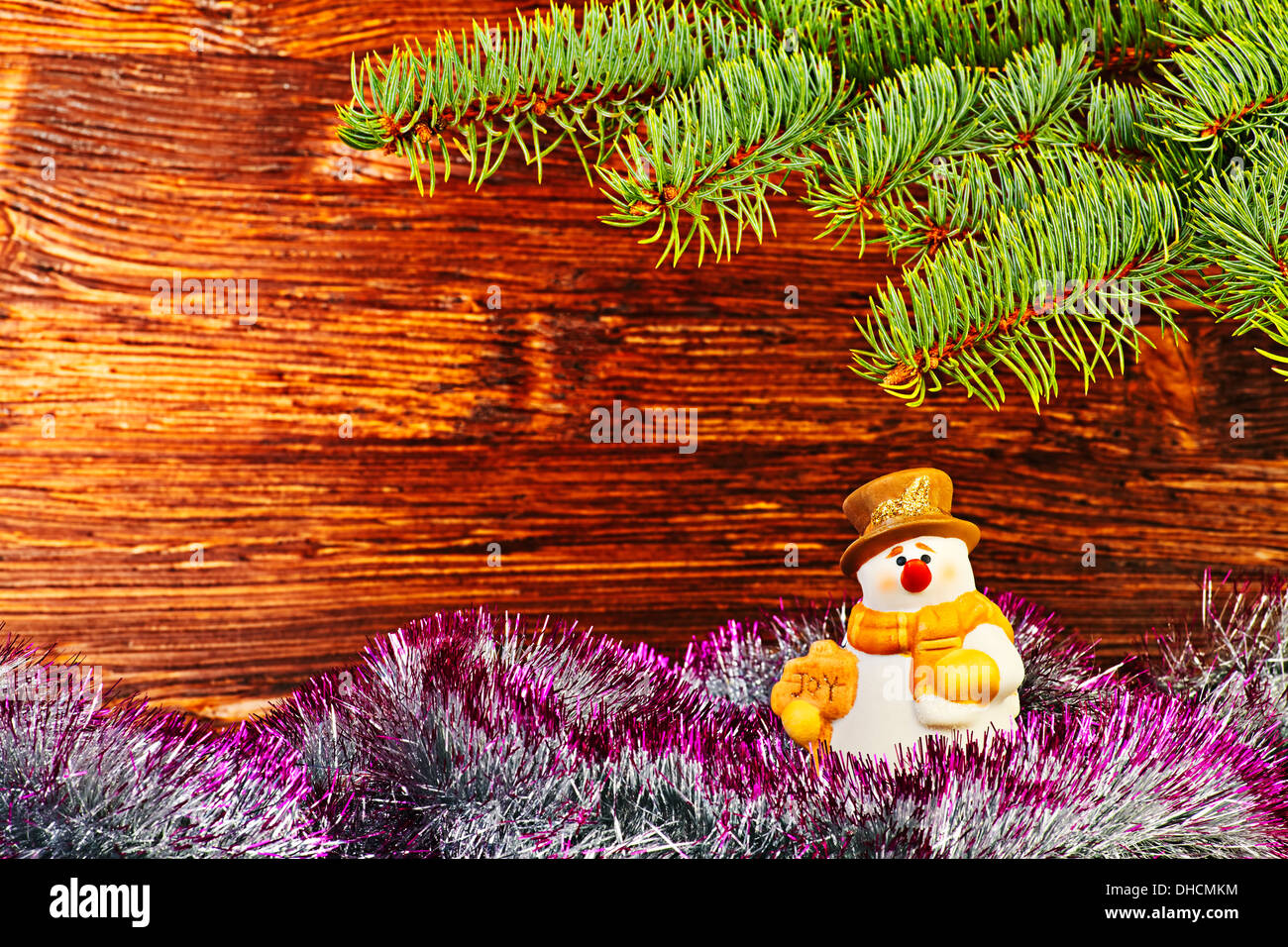 Christmas decoration. Snowman, tinsel and fir-tree. Selective focus Stock Photo