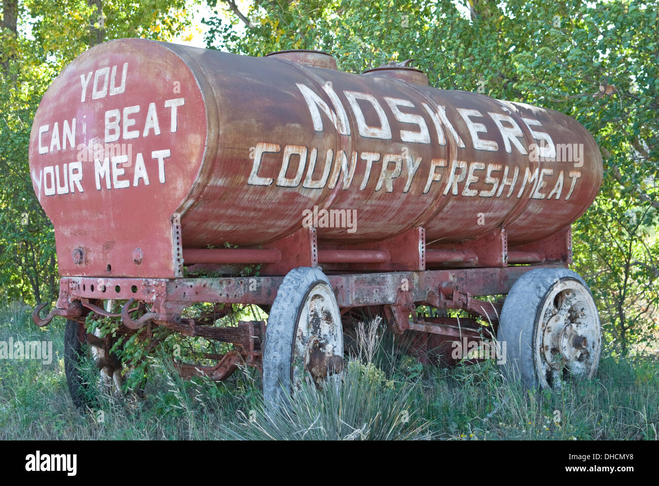 An ad on an old wagon is creatively defaced with a change of lettering. Stock Photo