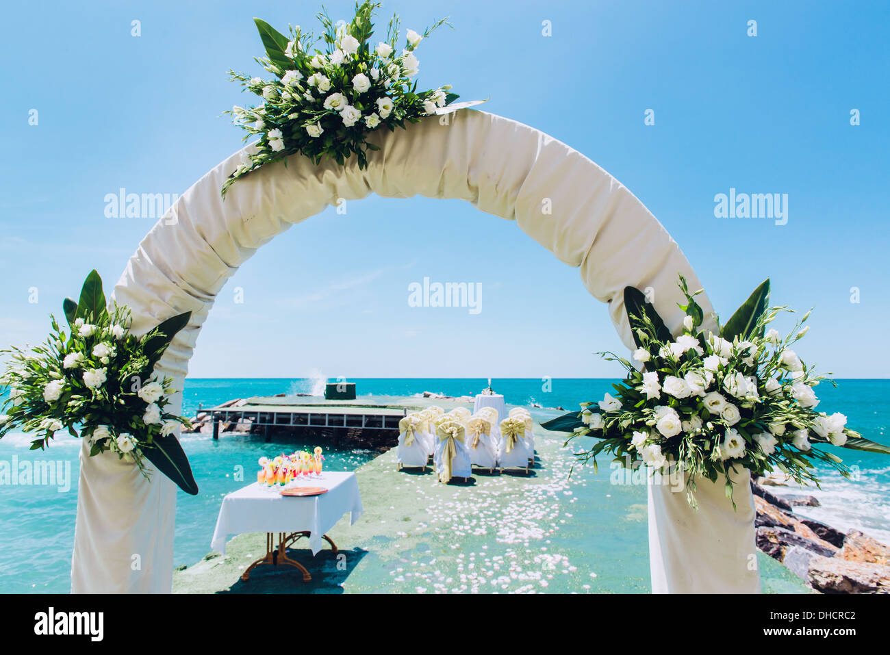 Wedding arch and wedding chairs on the empty beach Stock Photo