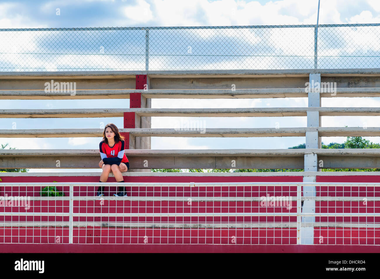 USA, Texas, American High School Girl in Sports Outfit sitting all