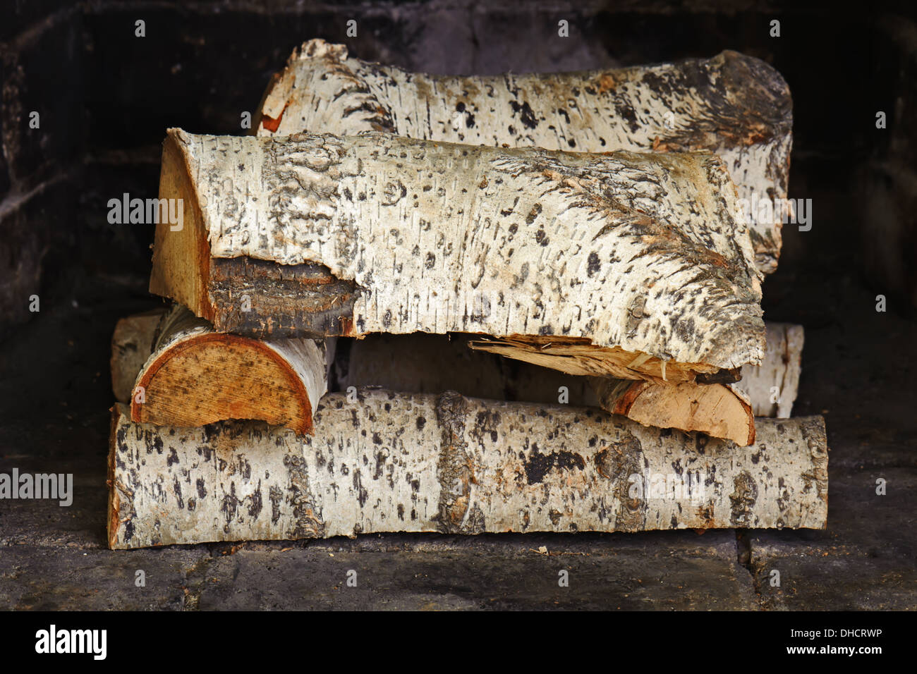 Fireplace with birch wood. Ready to light the flame Stock Photo - Alamy