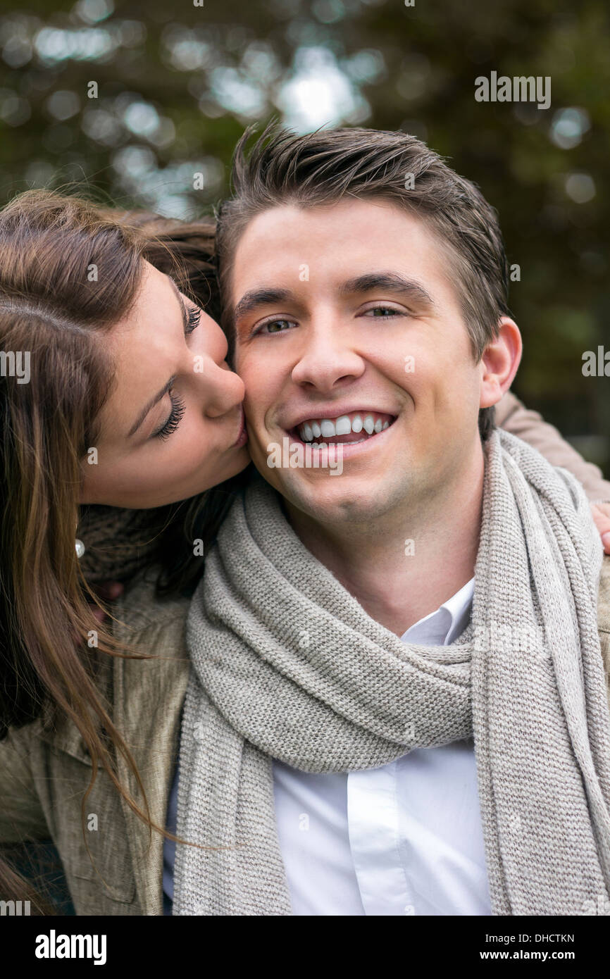 Woman kissing man outdoors Stock Photo - Alamy