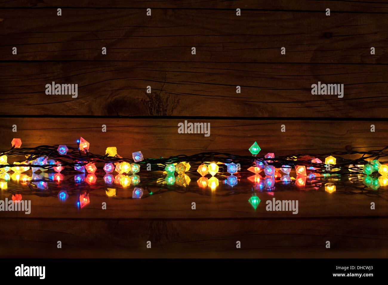 Christmas lights on dark wooden background with copy space, decorative ...