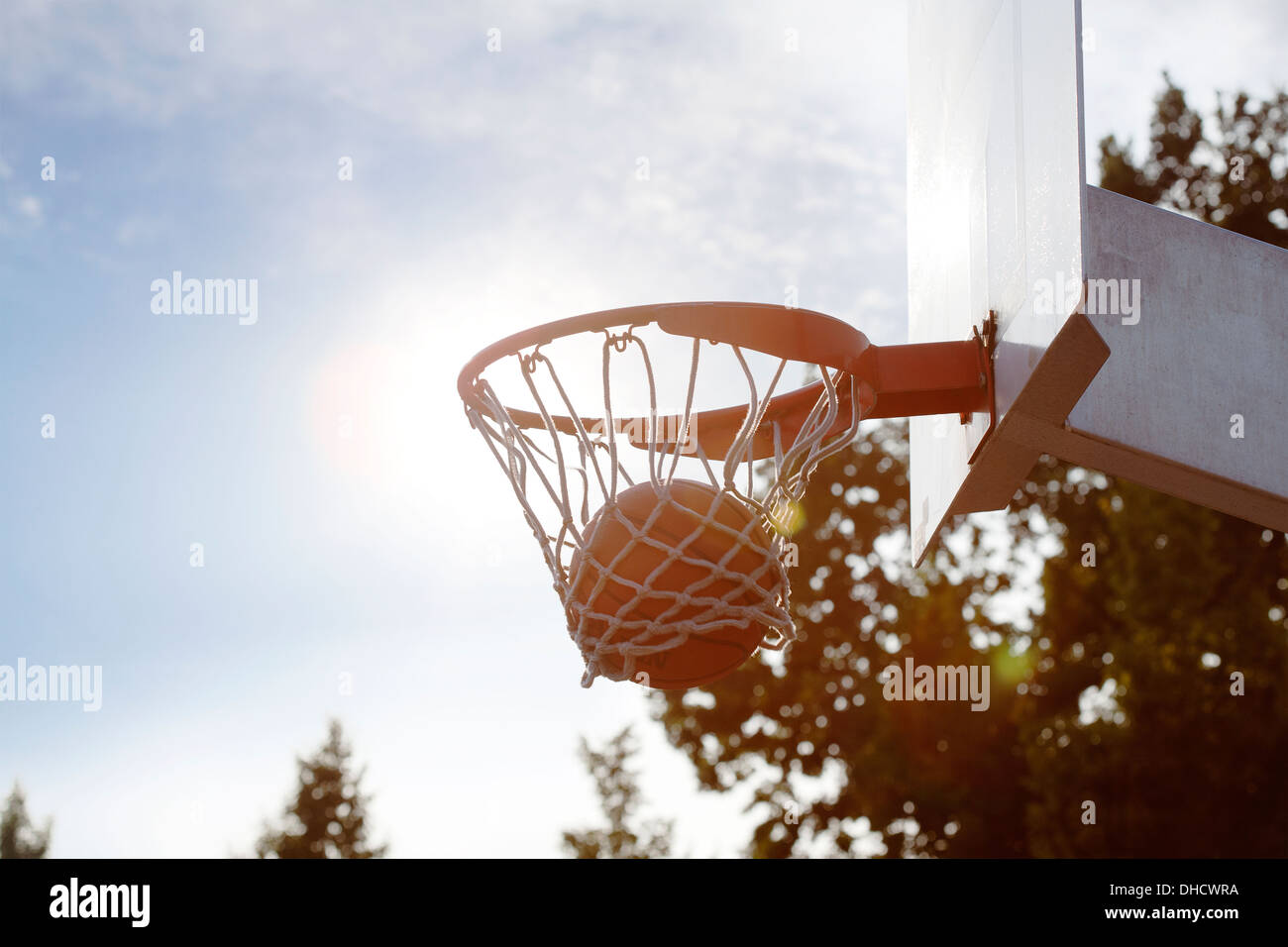 Ball in basketball hoop Stock Photo Alamy