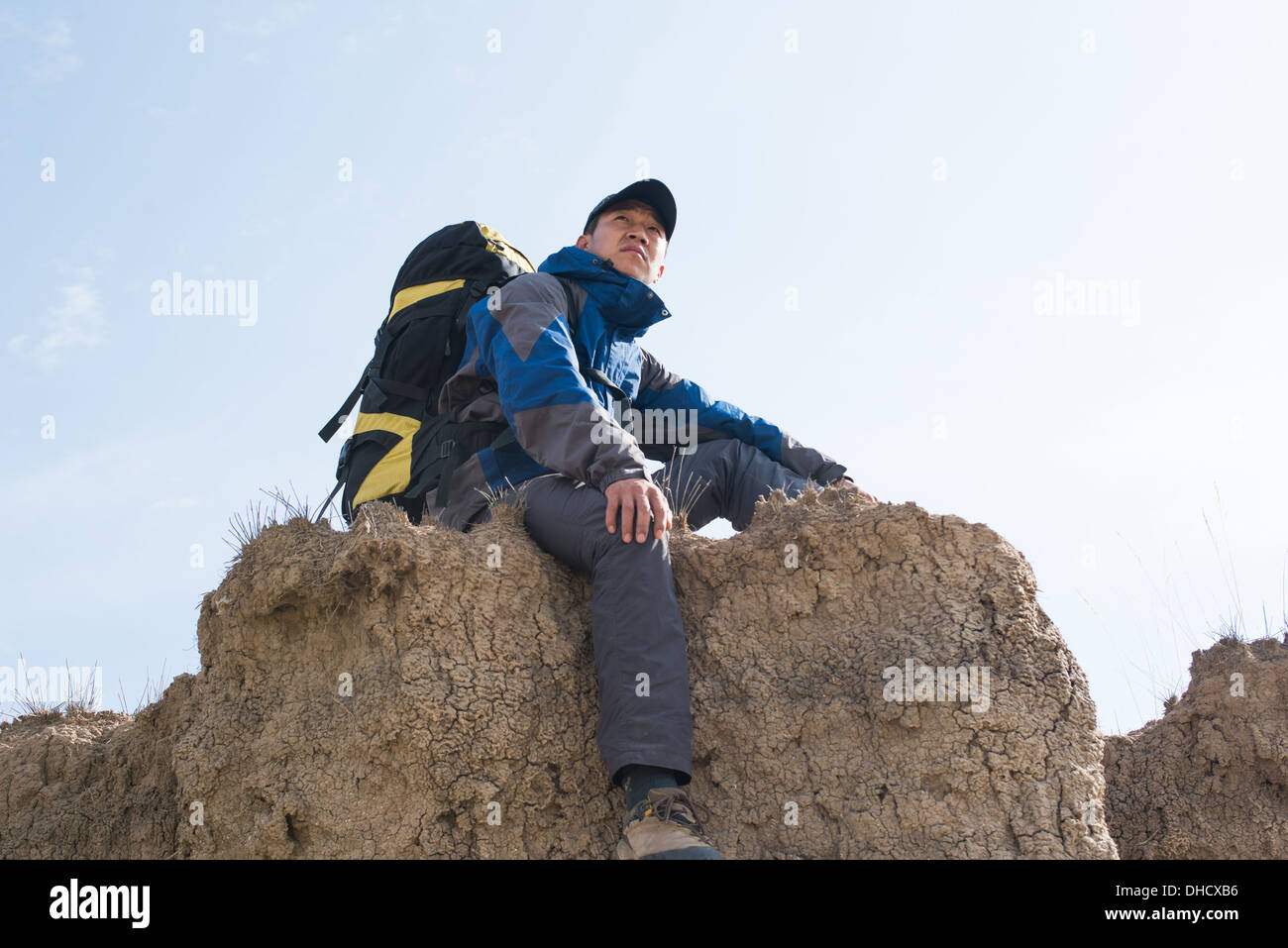 Sitting on a cliff resting hikers. Asian Youth Stock Photo