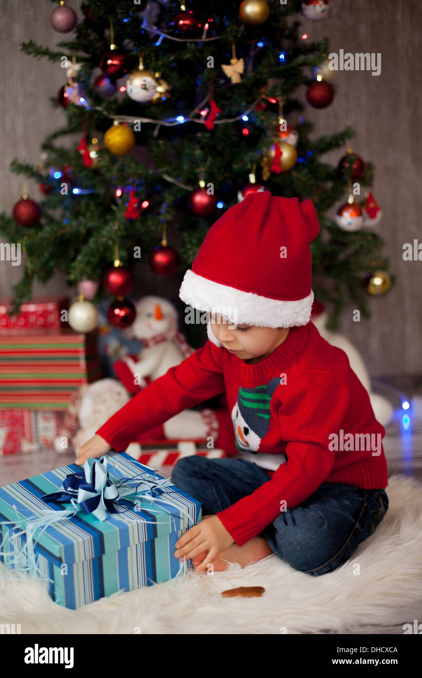 Little boy, opening presents on christmas Stock Photo