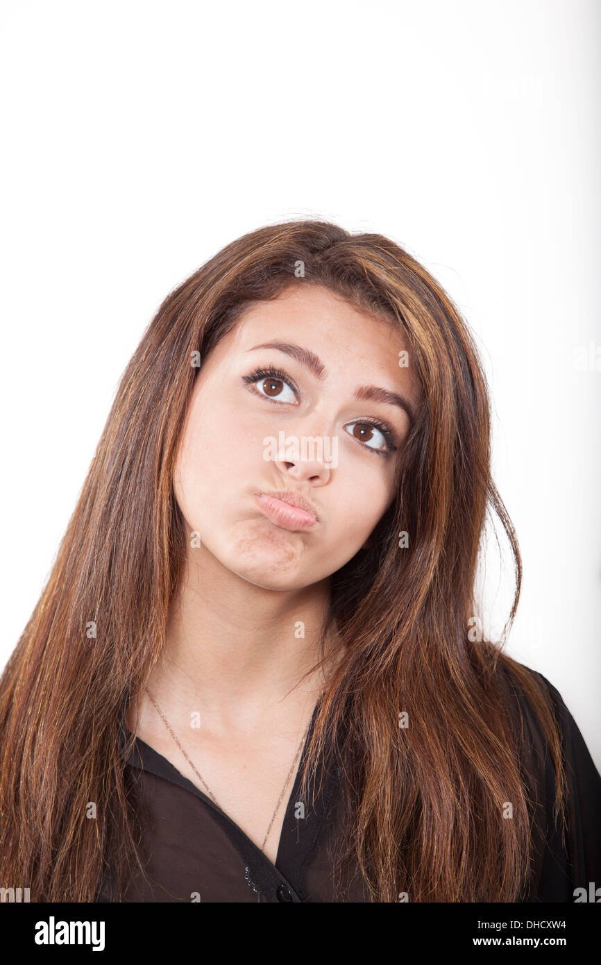 Mixed race teen girl pursing lips and thinking, pondering Stock Photo