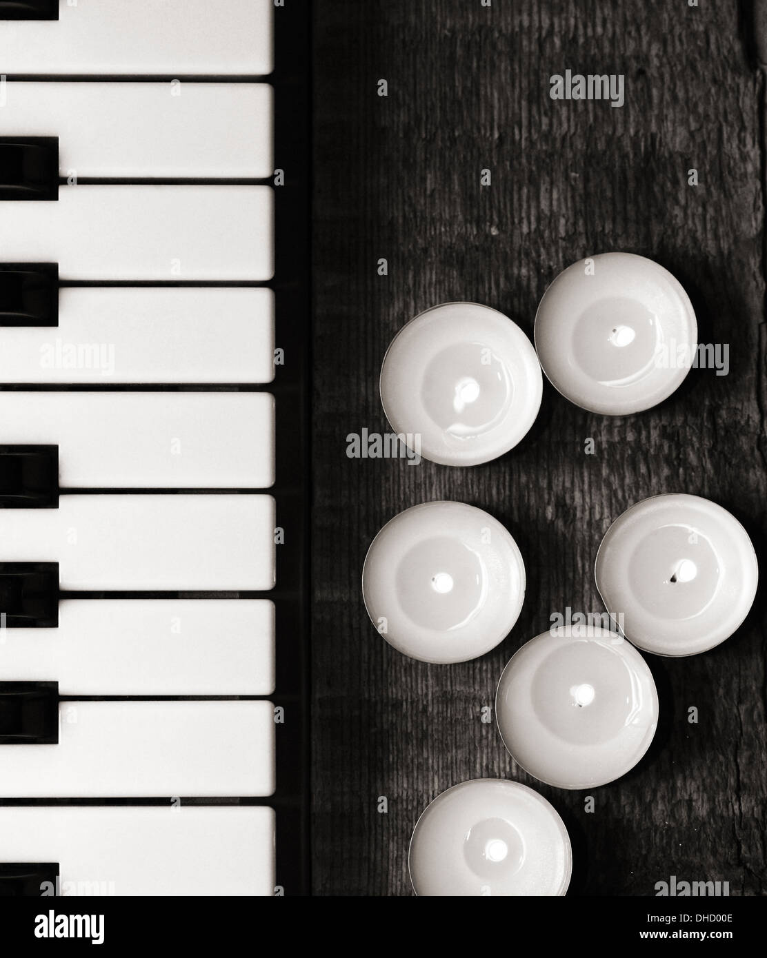 monochrome image, burning candles and pianoforte Stock Photo