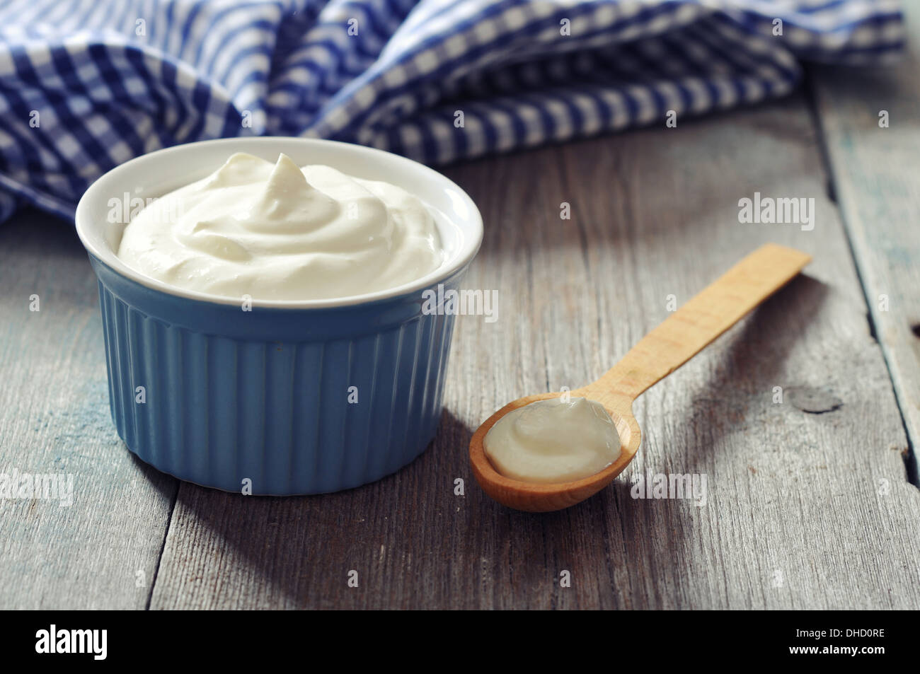 Greek yogurt in a ceramic bowl with spoons on wooden background Stock Photo