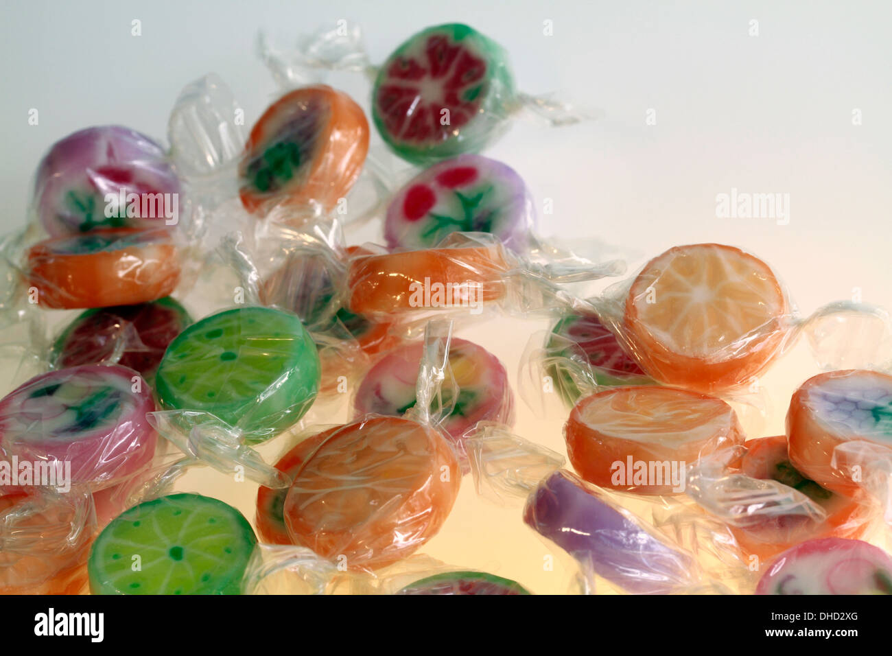 Brightly coloured rock candy sweets in cellophane wrappings. Stock Photo