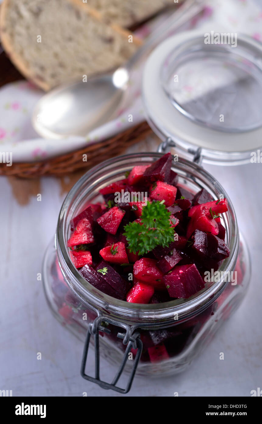 Beetroot salad in a preserving jar with olive bread Stock Photo