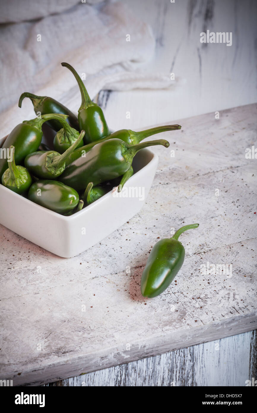 Green jalapeno chilis capsicum annuum in a bowl hires stock