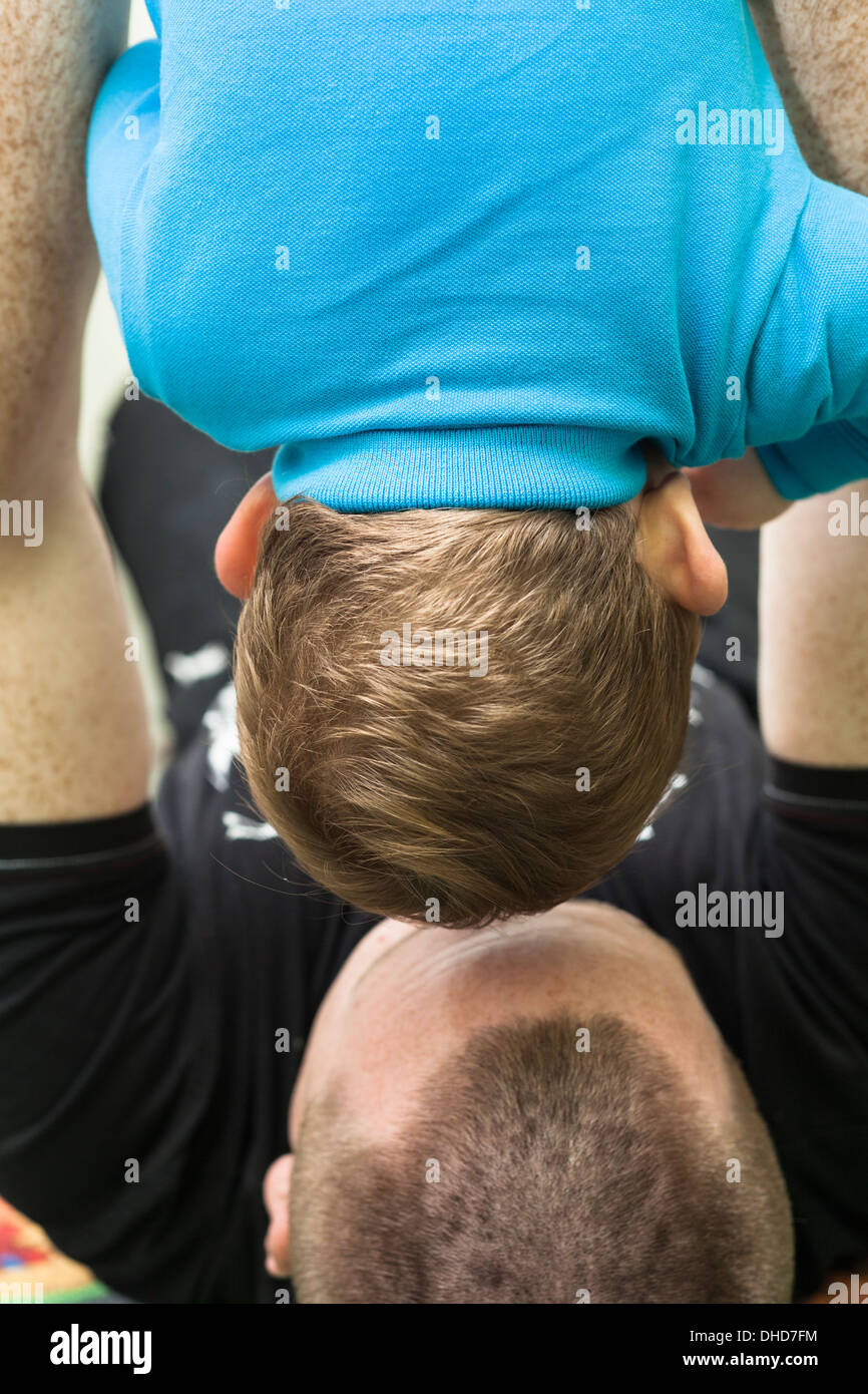 Closeup of daddy holding his son upside down. Stock Photo
