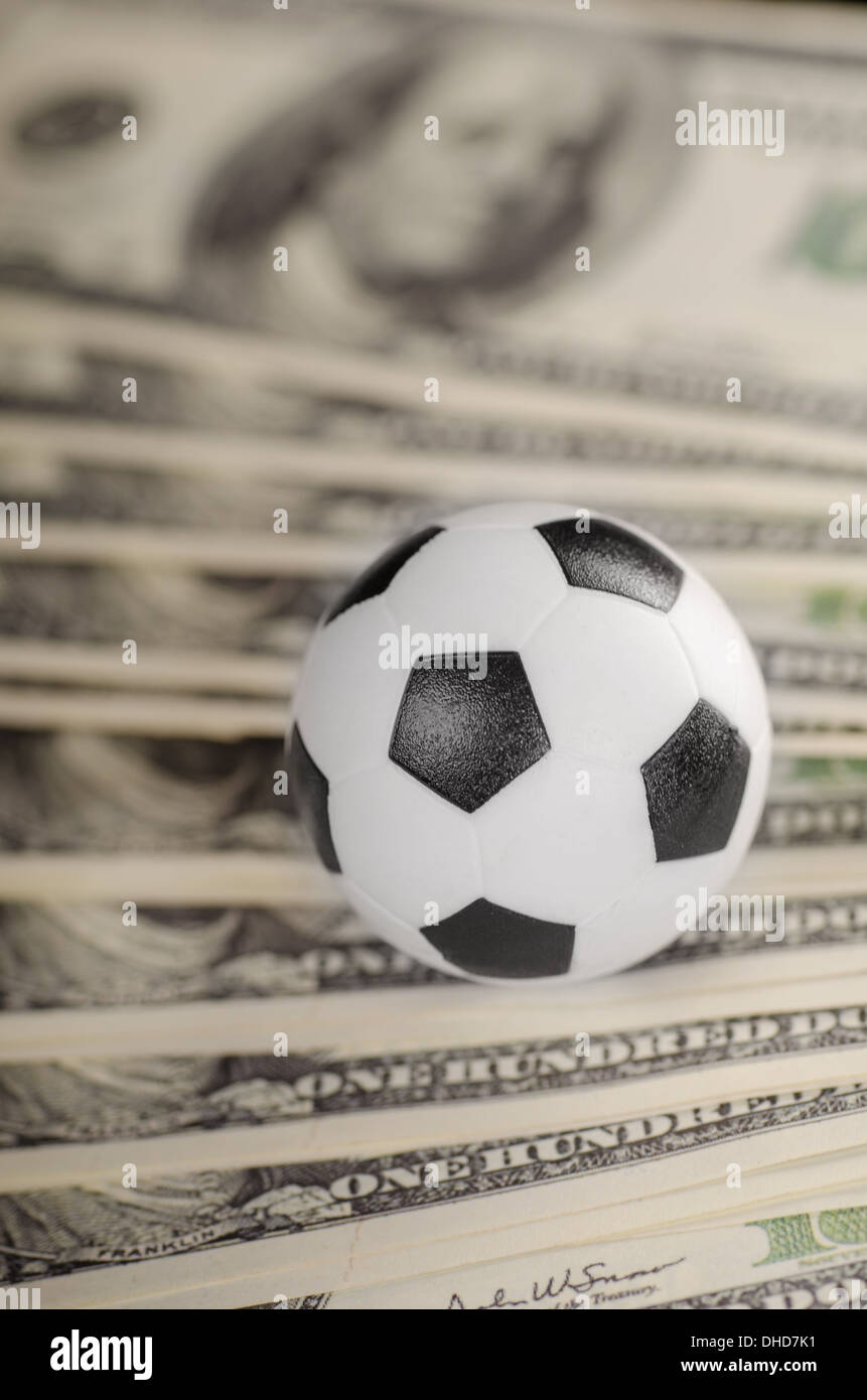 Soccer ball on background of dollars Stock Photo Alamy
