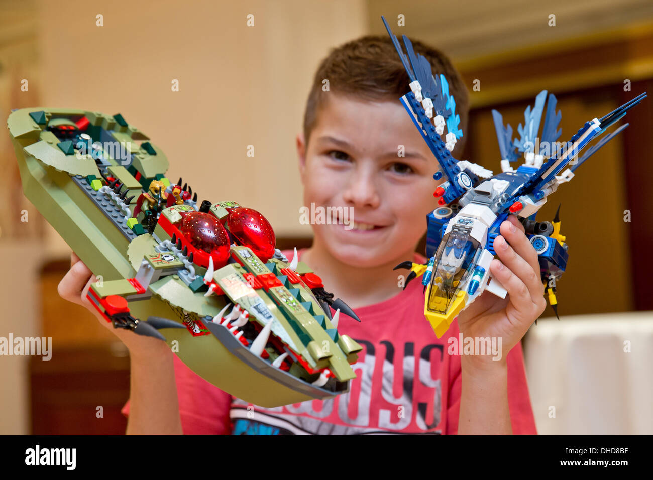 Nuremberg, Germany. 07th Nov, 2013. Max holds parts of the 'Legends of Chima' by LEGO at the annual press conference of the German federation of toys retail business in Nuremberg, Germany, 07 November 2013. The toy is part of the 'Top 10 Toys 2013' list published by the federation. Photo: DANIEL REINHARDT/dpa/Alamy Live News Stock Photo