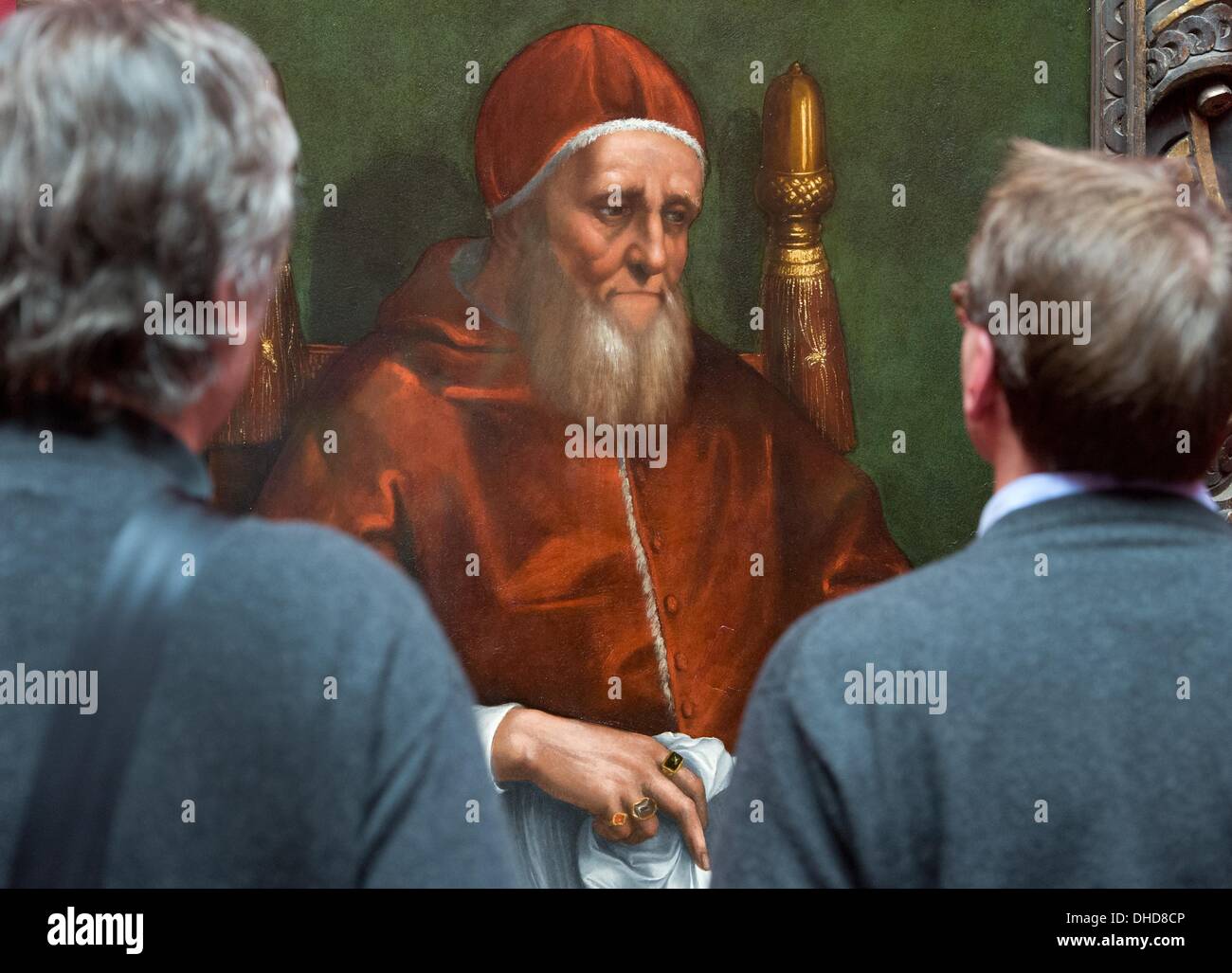 Frankfurt Main, Germany. 07th Nov, 2013. Visitors look at a portrait of Pope Julius II at the Staedel museum in Frankfurt Main, Germany, 07 November 2013. The Staedel Museum acquired the hitherto unknown version of the Portrait of Pope Julius II by Raphael and his workshop, which will be addressed in a showcase exhibition from 08 November 2013 to 16 February 2014. Photo: BORIS ROESSLER/dpa/Alamy Live News Stock Photo
